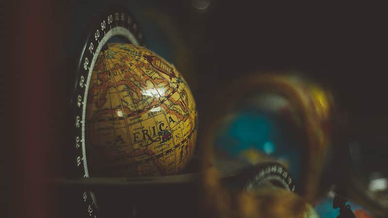 Close-up of a vintage globe showing the continent of Africa, with other out-of-focus globes in the background, reminiscent of Advanced Pricing Agreements (APAs) navigating intricate international terrains.